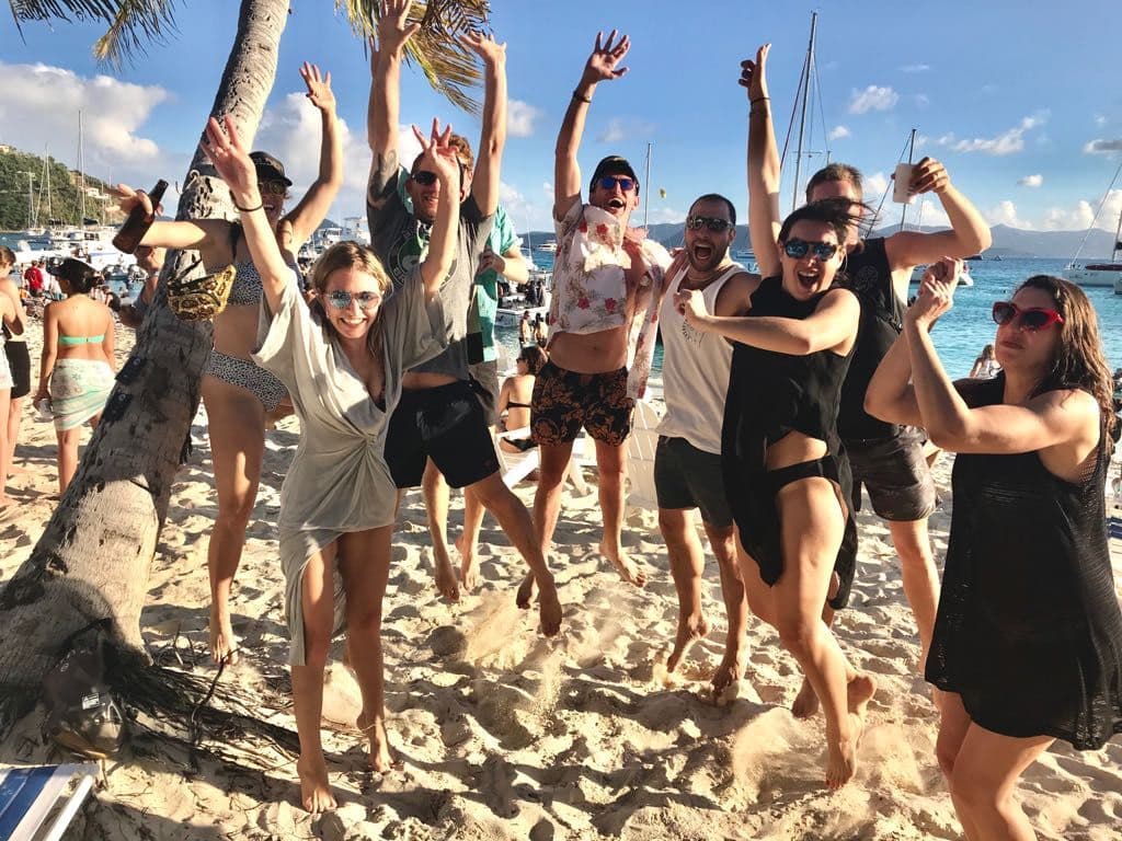 Crew cheering on a beach