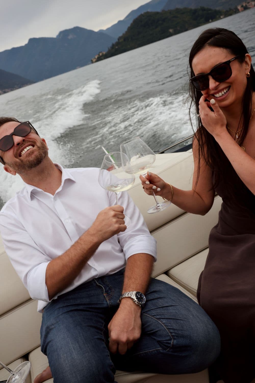 Guest laughing on a boat on Lake Como