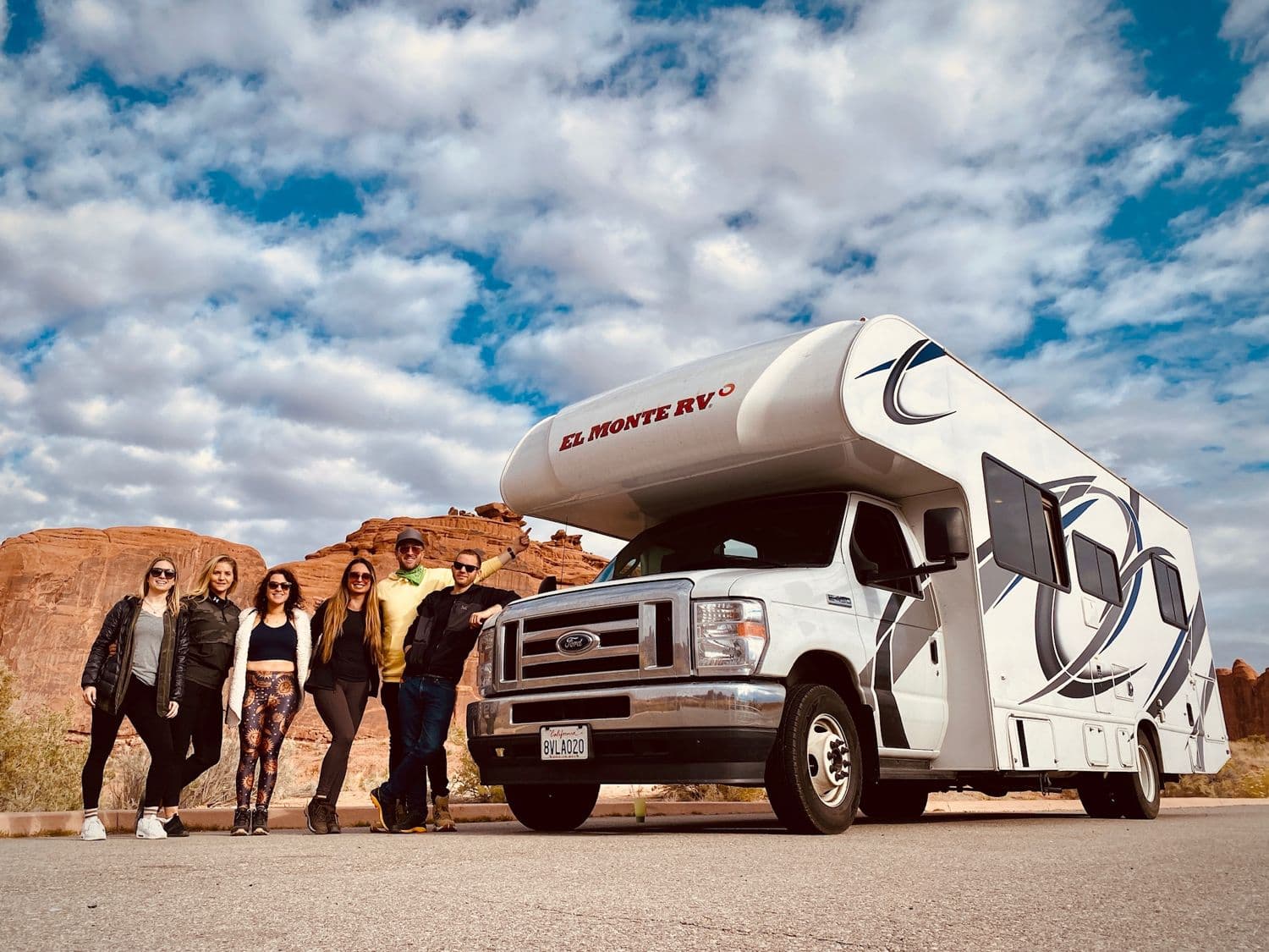 The crew and the rented RV parked in red-rock desert