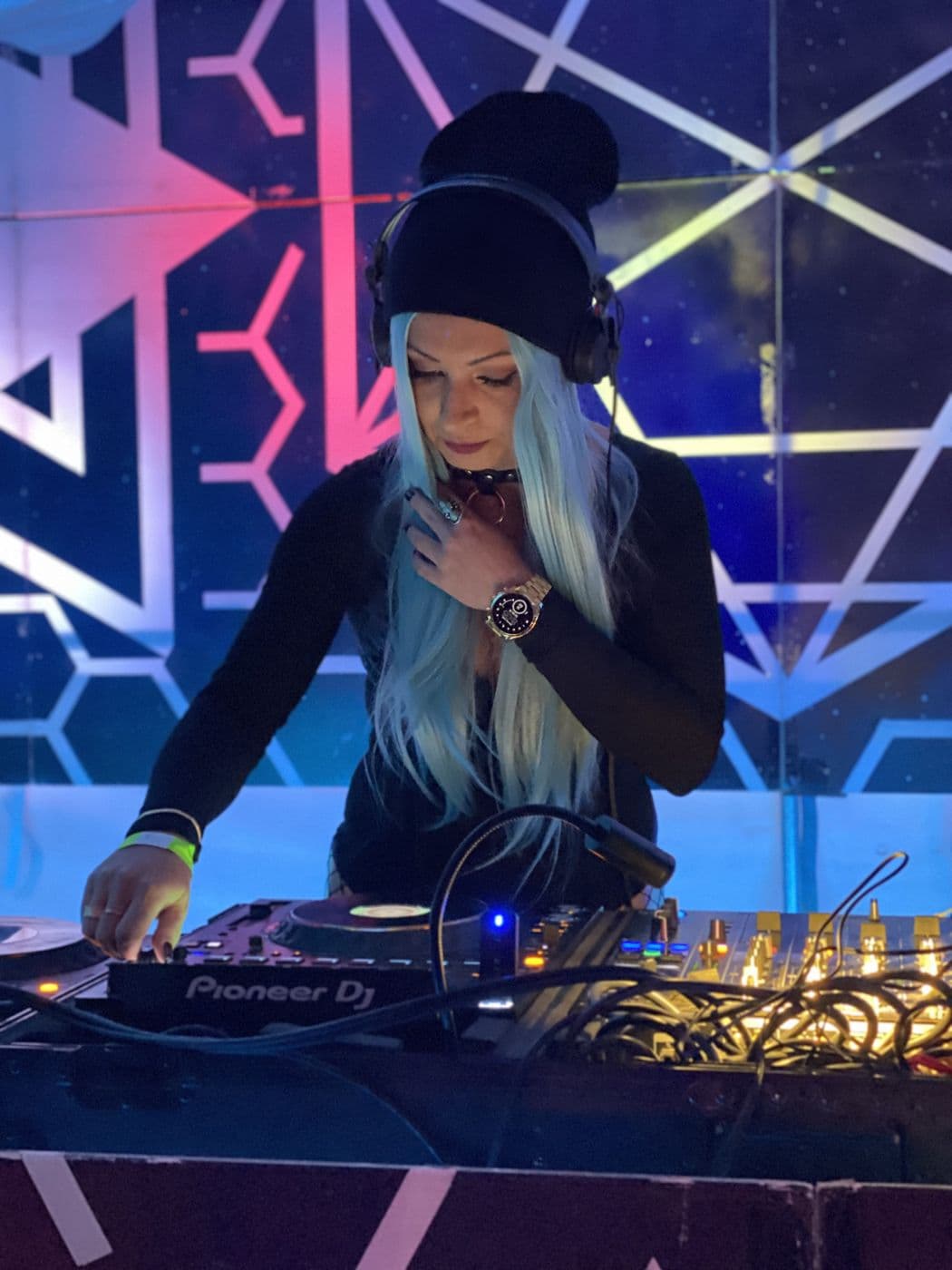 DJ set under blue geometric lights