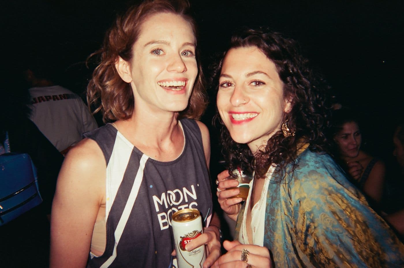 Friends laughing at a party, shot on film