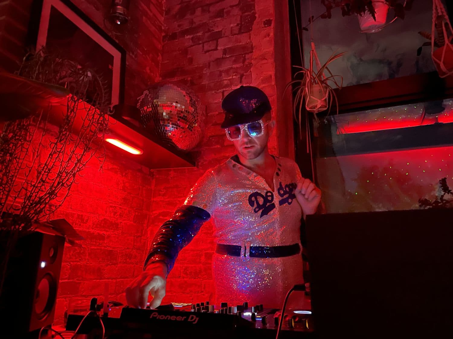 The DJ in costume under red light