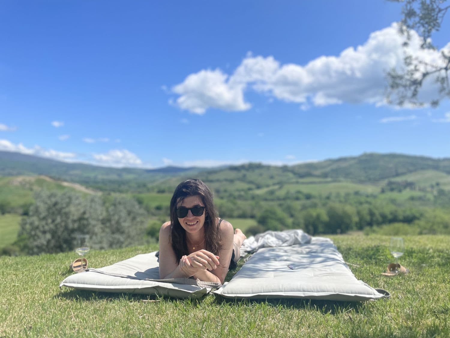 Sprawled on a blanket over a green valley