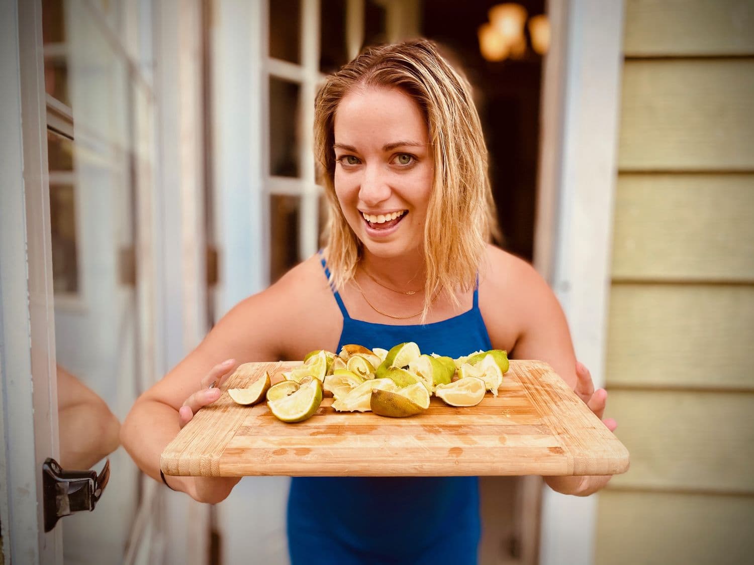 Fresh-cut limes on a board behind the bar