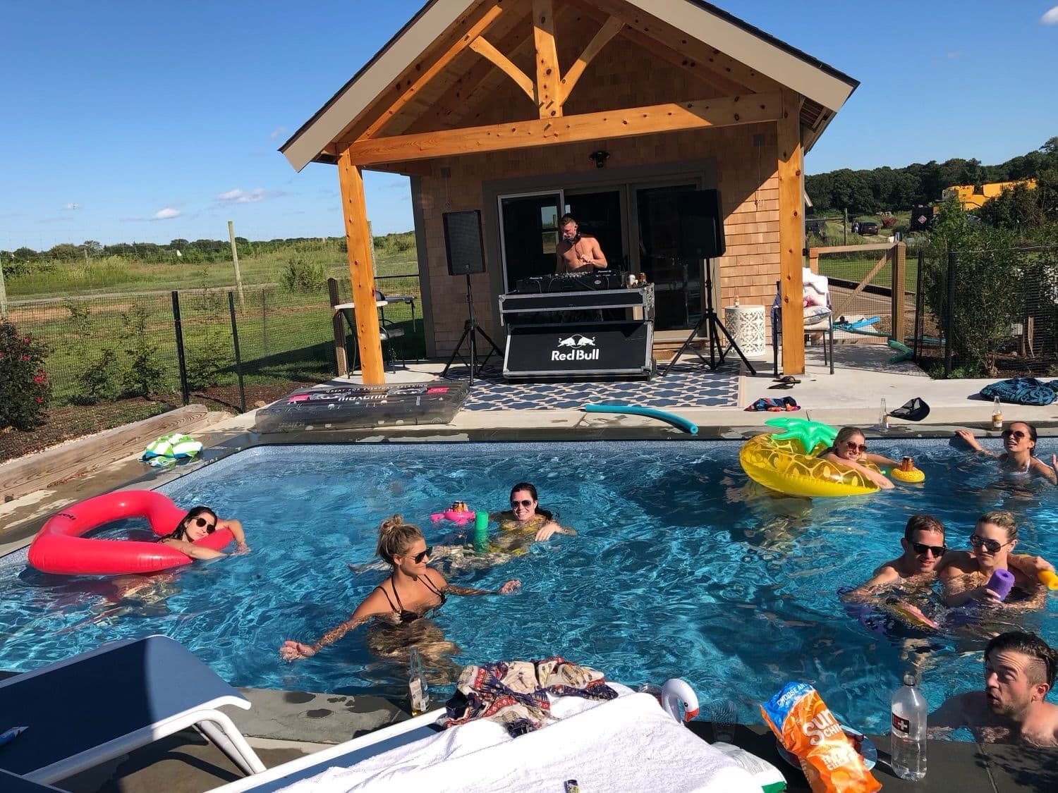 Pool party with DJ playing under a cabana