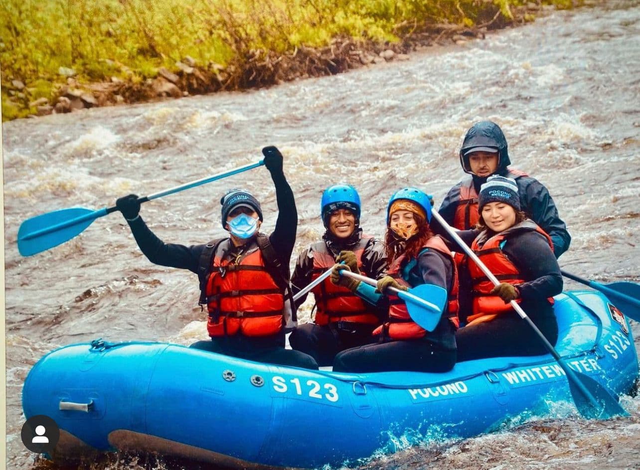 Whitewater rafting crew mid-rapid