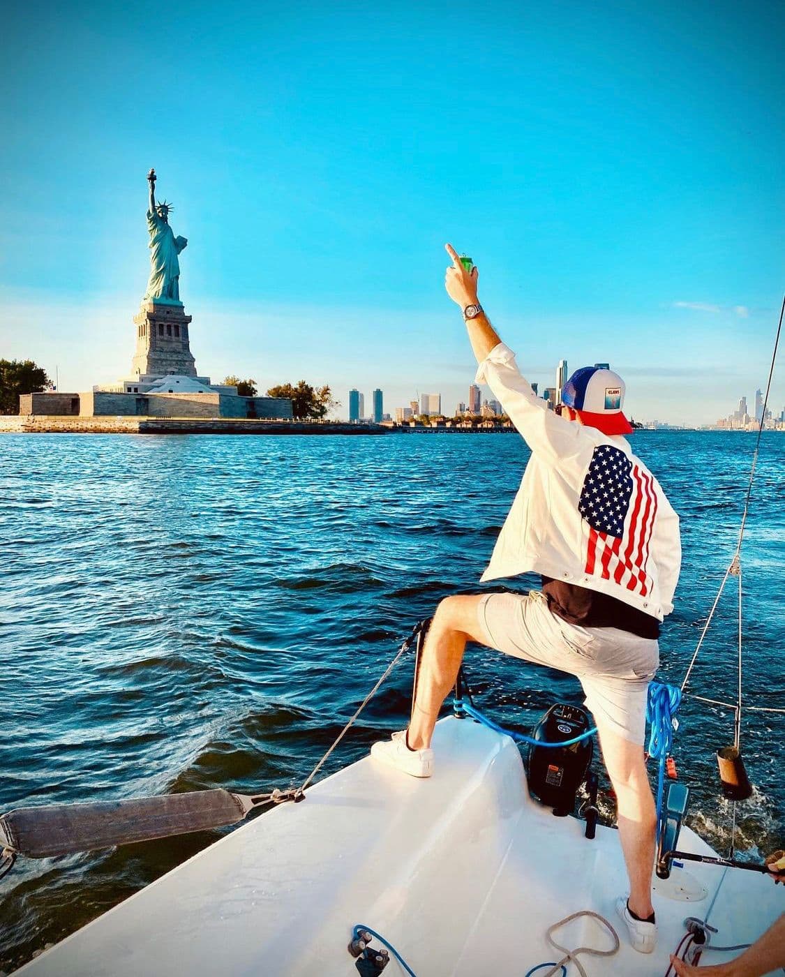 Pointing at the Statue of Liberty from the bow