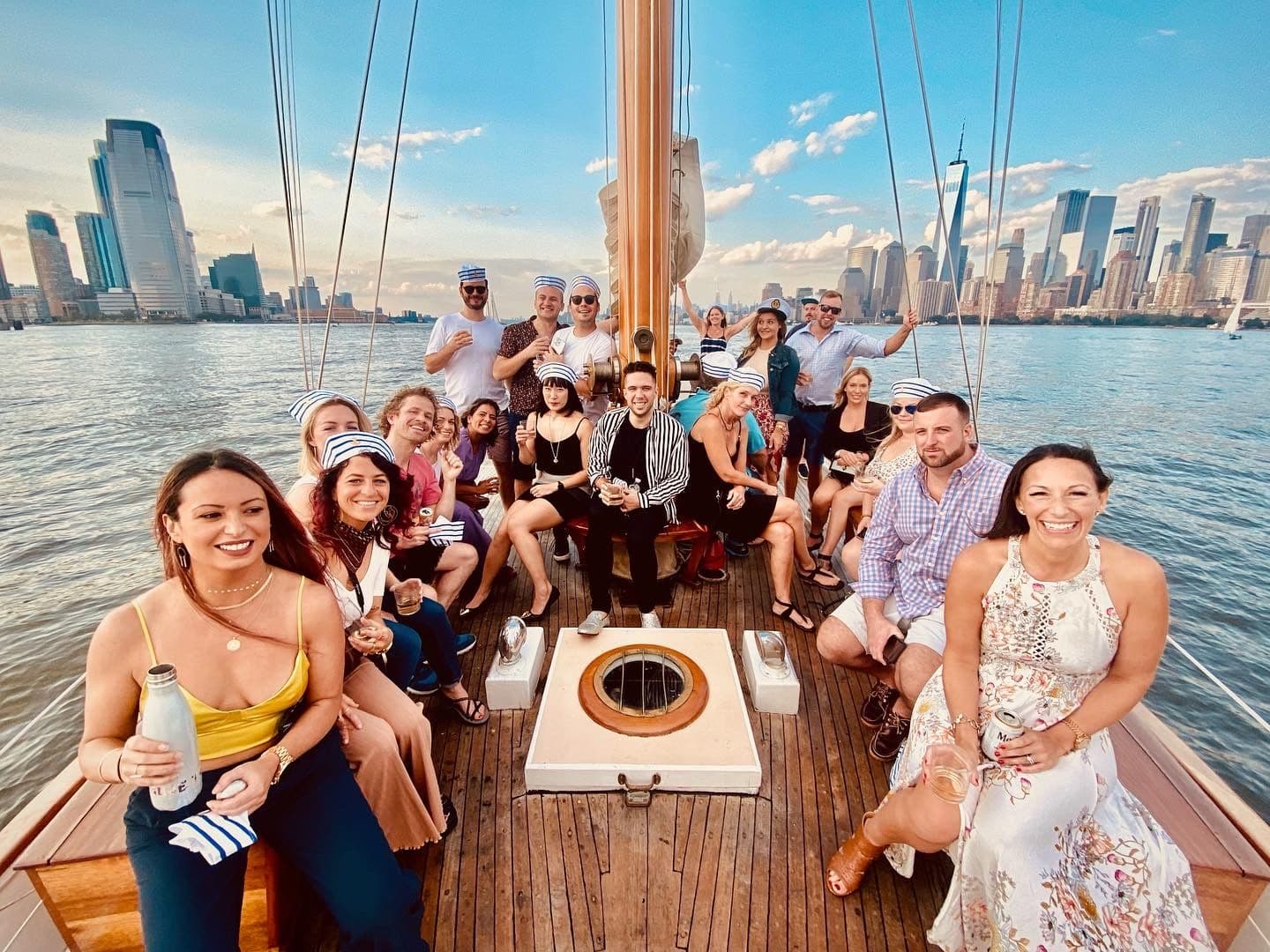 Group on a sailboat in front of the Manhattan skyline