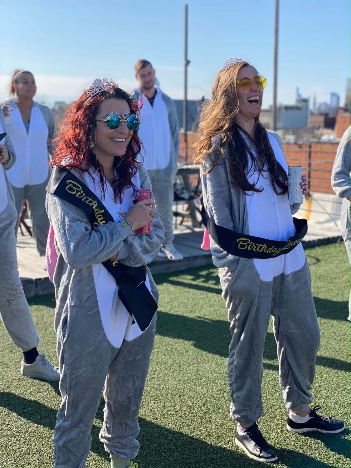 Crew in matching sashes on a rooftop