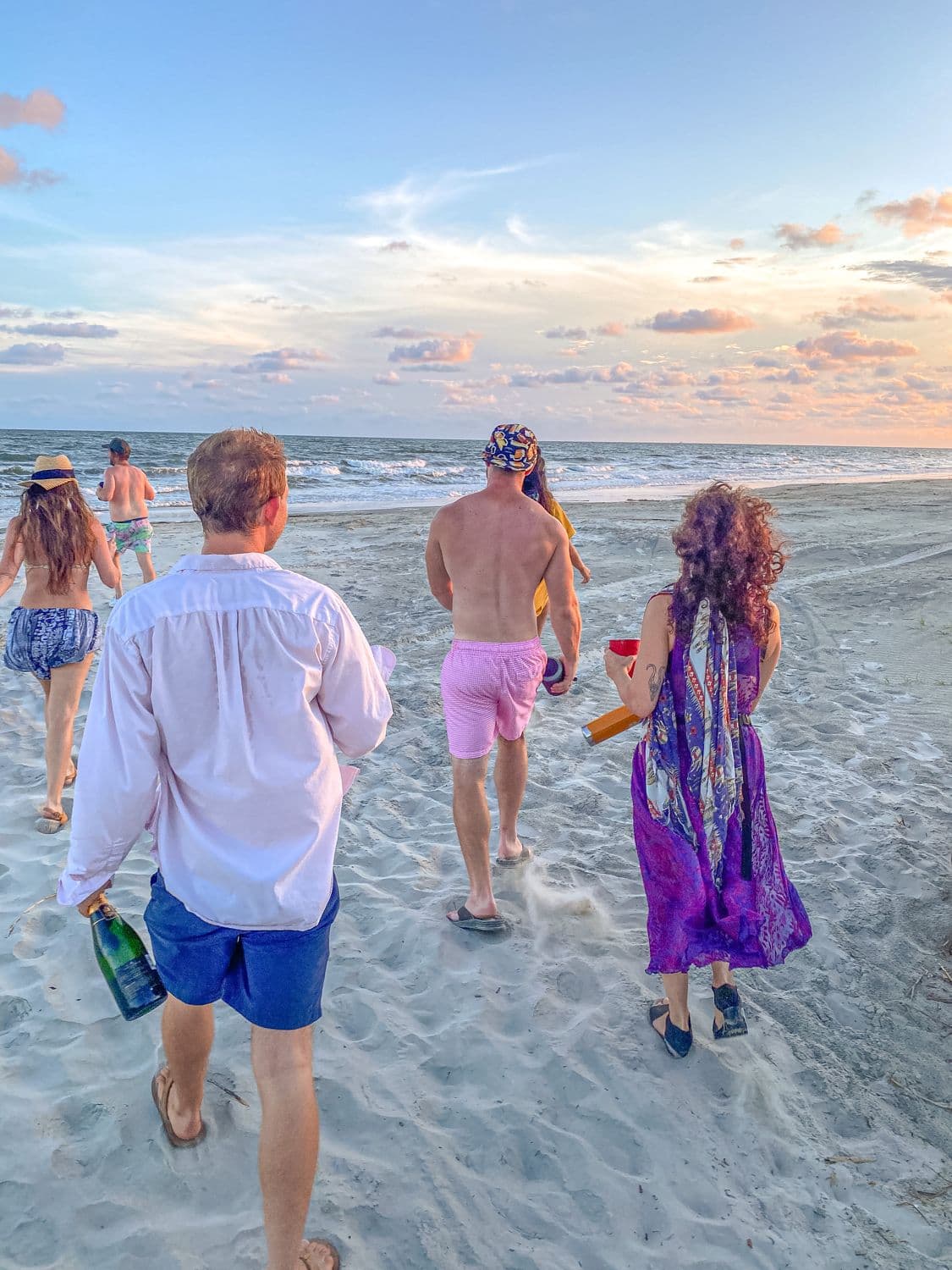 The crew walking the beach at dusk, dressed for dinner