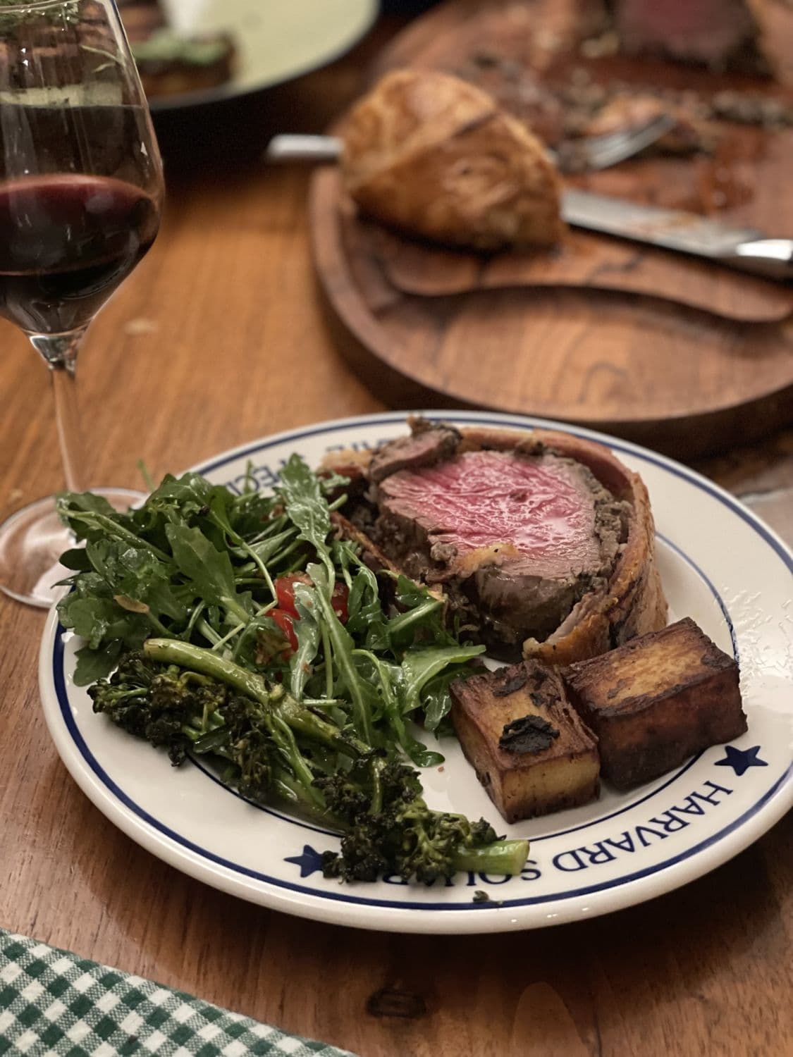 Beef wellington, plated, with a glass of red
