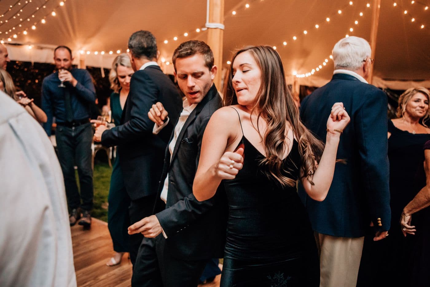 Guests dancing at a private tented event