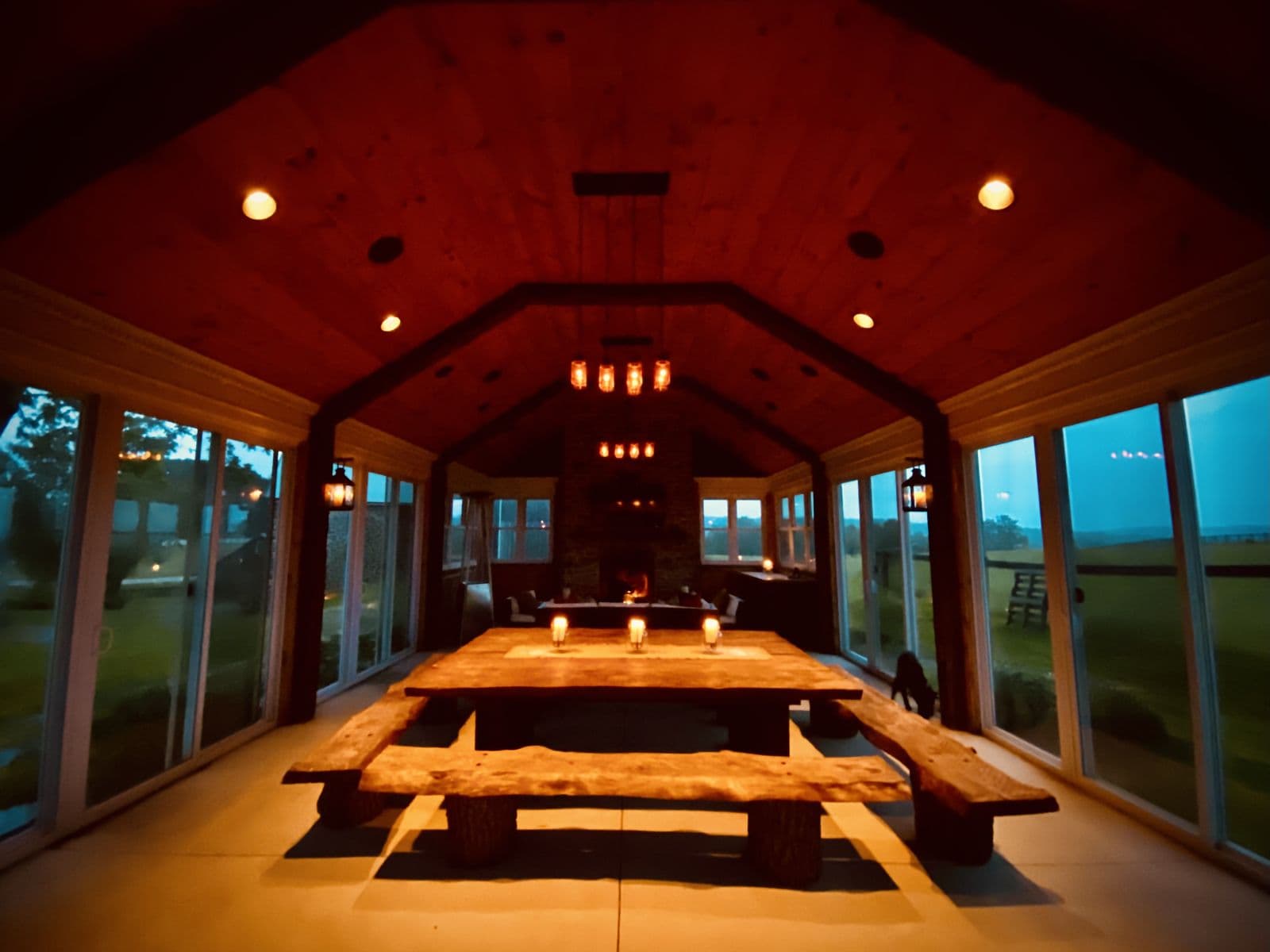 Warm timber event hall with long candlelit tables