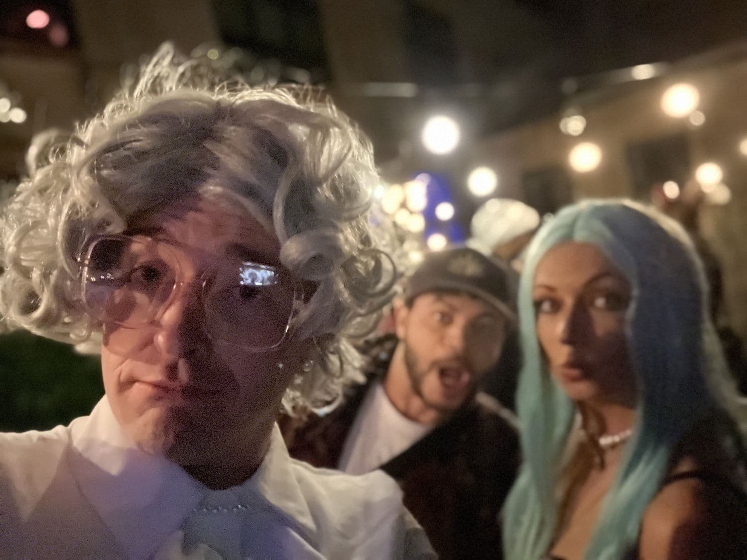 Three guests in full costume and wigs on Halloween