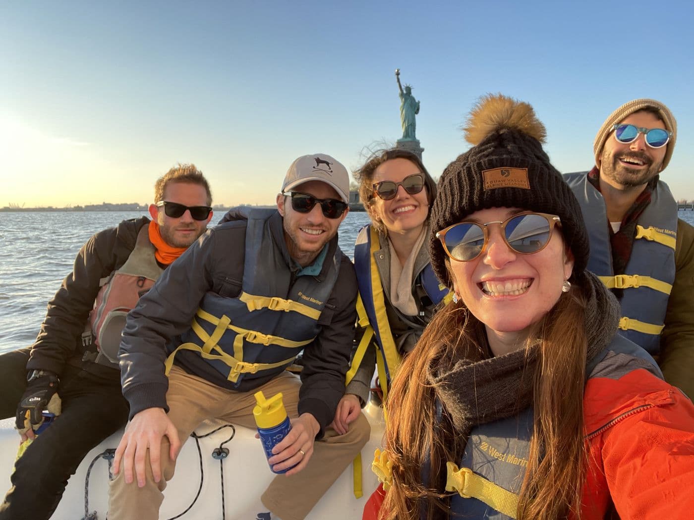 Crew in life vests sailing New York Harbor in winter