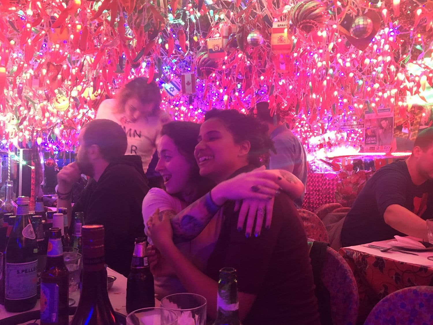 A birthday embrace under the pink lights