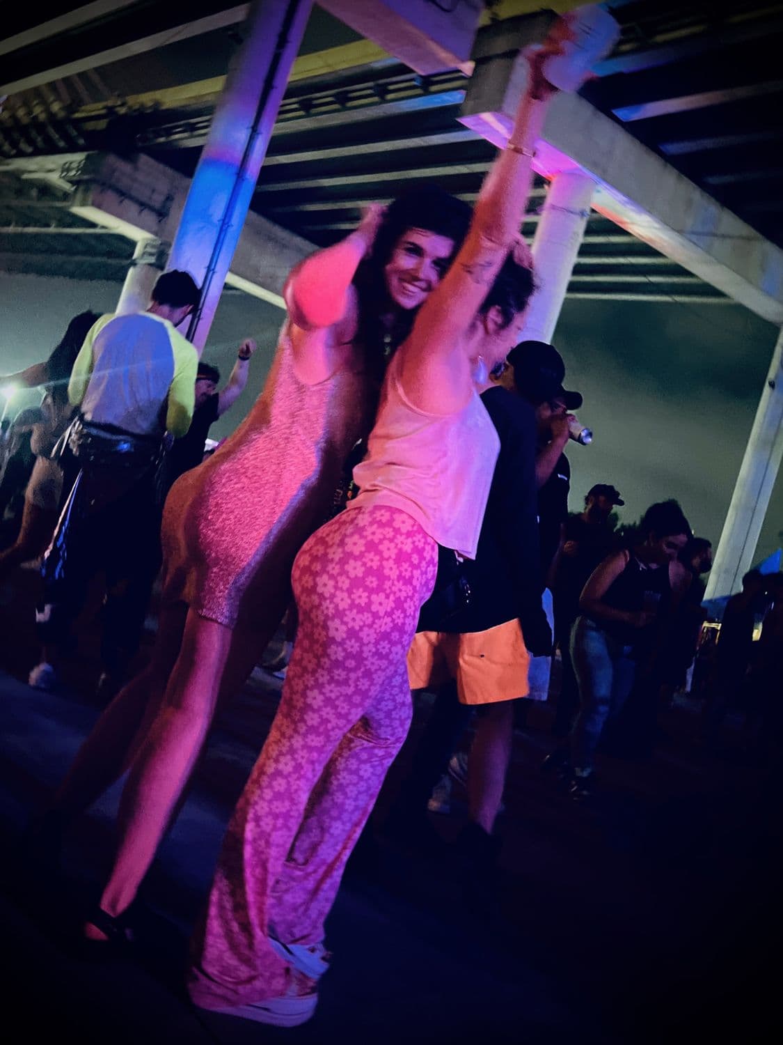 Dancing under the Kosciuszko Bridge in pink light
