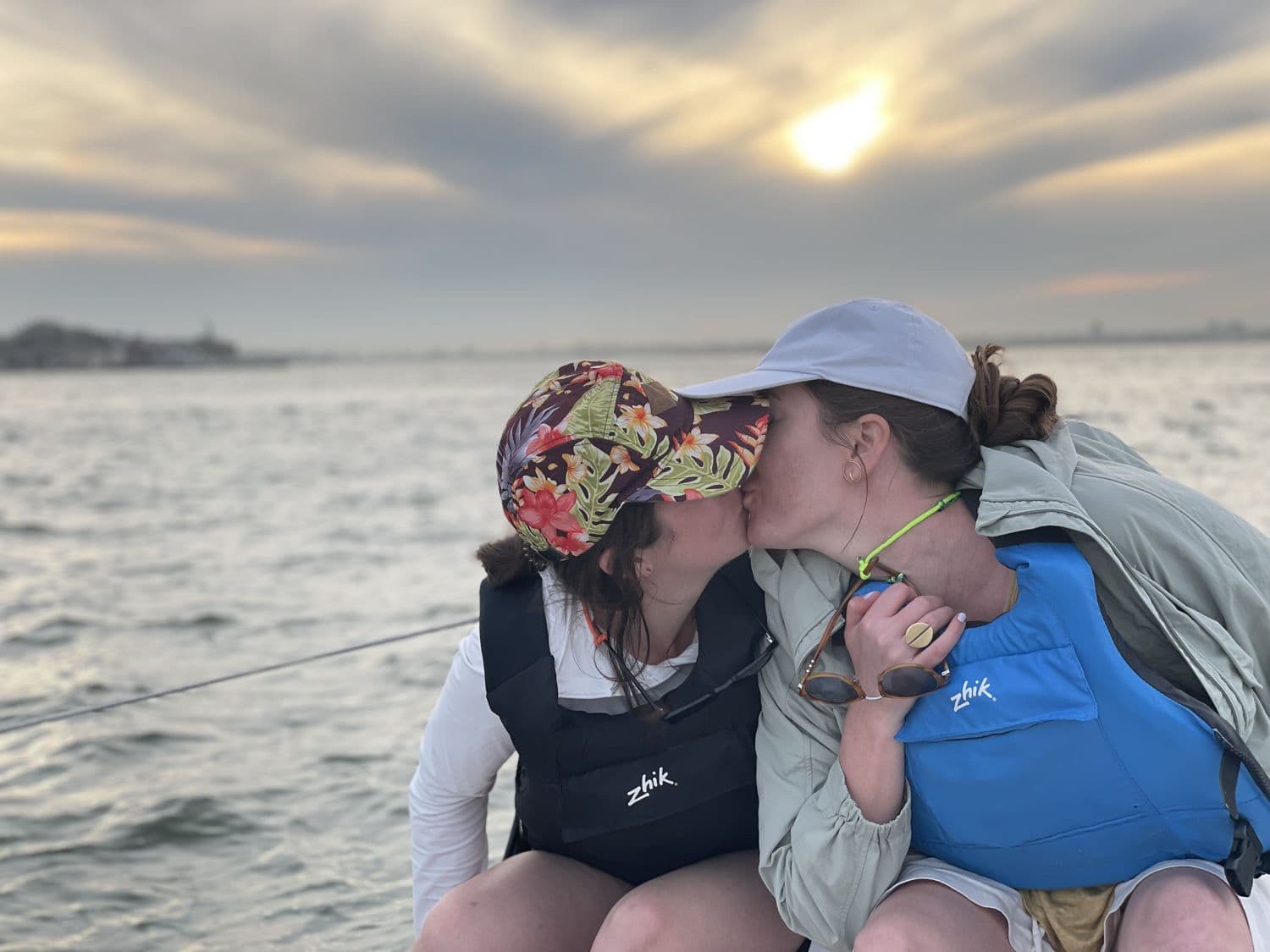 A kiss on the bow in matching life vests
