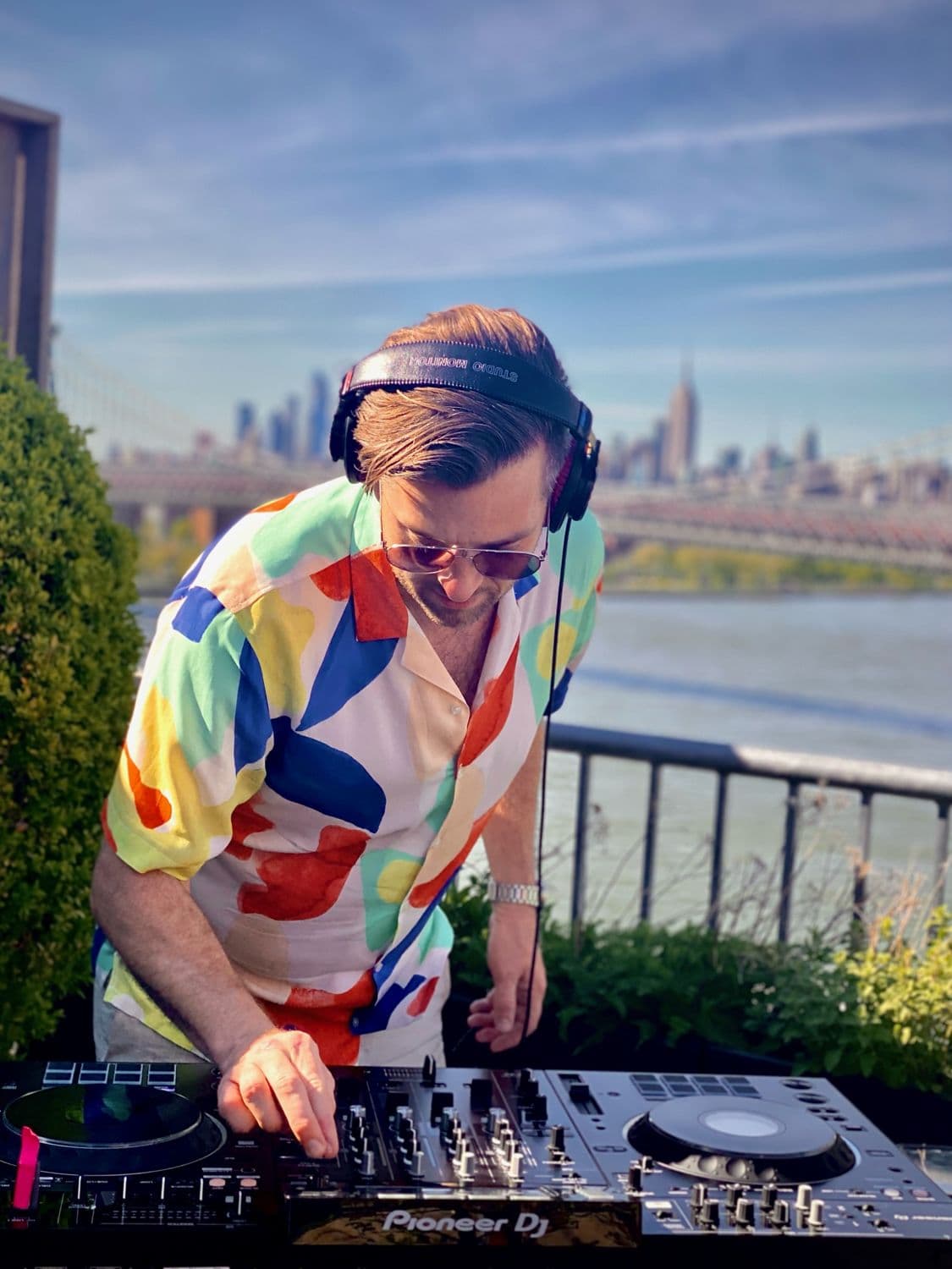 Resident DJ on the decks with the Manhattan skyline behind