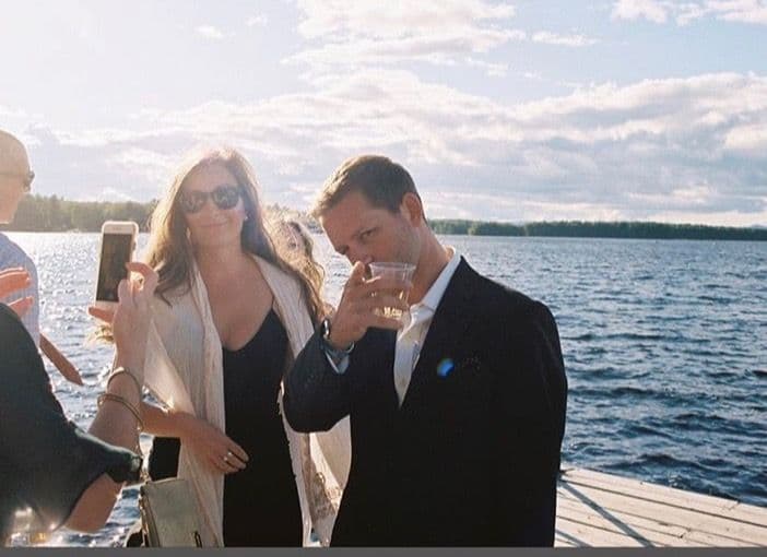 A champagne toast on the dock at dusk