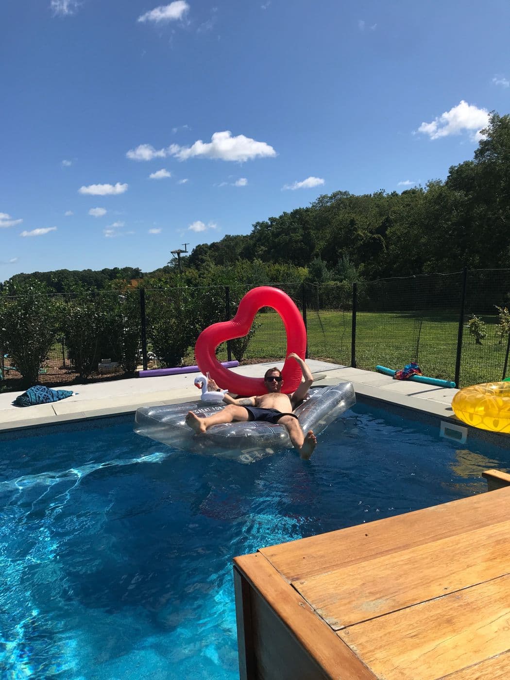 A heart-shaped floatie in the farmhouse pool