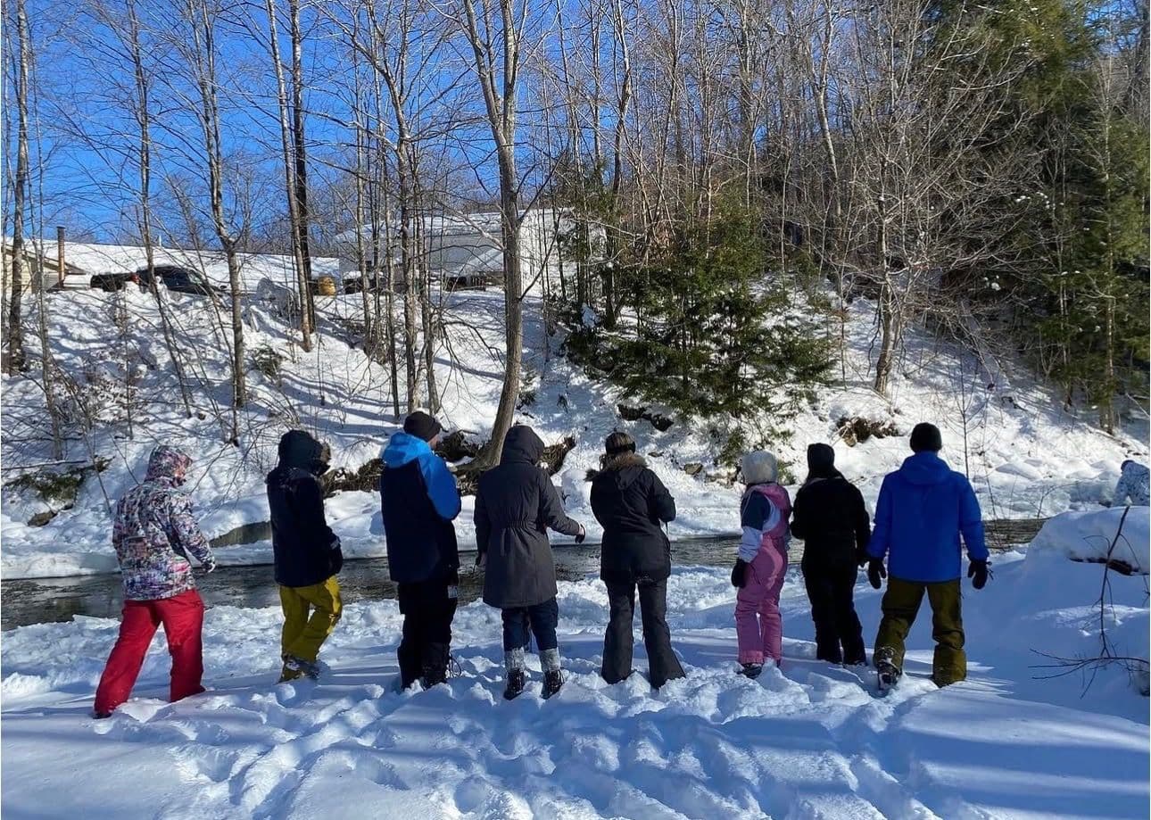 The crew hiking through the snow to the lift